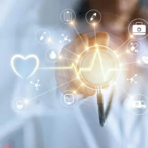 A doctor is holding an electronic device with the image of a heart beat.