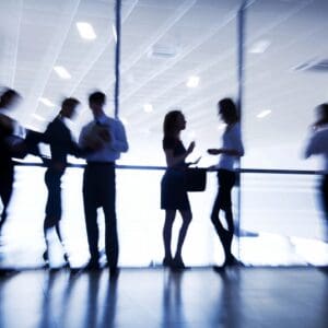 Blurred silhouettes of businesspeople in office